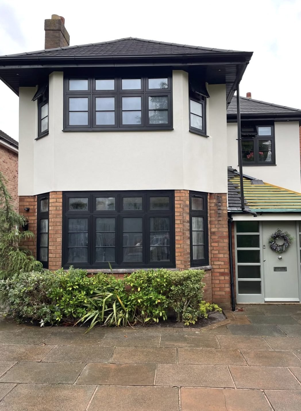 Semi-detached house with render on the upper bay and brick below